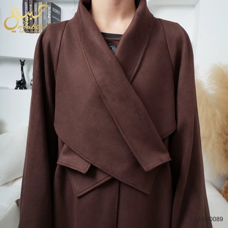 Long brown crossover coat with buttons.