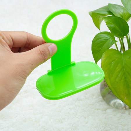 Phone holder for wall socket