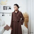 Long brown crossover coat with buttons.